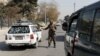 A Taliban fighter stands as he guards a checkpoint in Kabul, Afghanistan Nov. 27, 2021. 