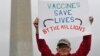 Ben Prickril poses for a portrait with a sign that reads "Vaccines Save Lives By The Millions" at the March for Science event in Washington, April 22, 2017.