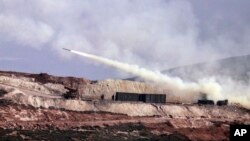 Turkish artillery fires toward Syrian Kurdish positions in Afrin area, Syria, from Turkish side of the border in Hatay, Turkey, Feb. 9, 2018. Turkish jets have resumed airstrikes in the Syrian Kurdish-run enclave of Afrin, the military and media reports 