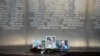 Flowers are placed by portraits of slain journalists Alexander Rastorguyev, Kirill Radchenko and Orkhan Dzhemal, at the Russian journalists Union building in Moscow, Russia, Wednesday, Aug. 1, 2018. 