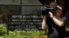 A cameraman films outside the Arango Orillac Building that lists the Mossack Fonseca law firm in Panama City, April 5, 2016. Documents leaked from the firm include details of how some of the globe's richest people funnel assets into secretive shell companies.