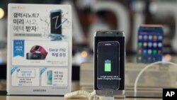 In this Sept. 8, 2016 photo, a Samsung Electronics' Galaxy Note 7 smartphone is displayed at the headquarters of South Korean mobile carrier KT in Seoul, South Korea. 