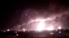 Fires burn in the distance after a drone strike by Yemen's Iran-aligned Houthi group on Saudi company Aramco's 