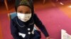 FILE - Amira Hassan, of Burnsville, Minnesota, plays in the waiting room at the specialty clinic at Children's Minnesota in Minneapolis, Minnesota, May 2, 2017.