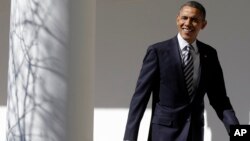 President Barack Obama looks towards reporters as he walks down the West Wing Colonnade of the White House on February 12, 2013, ahead of his State of the Union speech on Capitol Hill. 