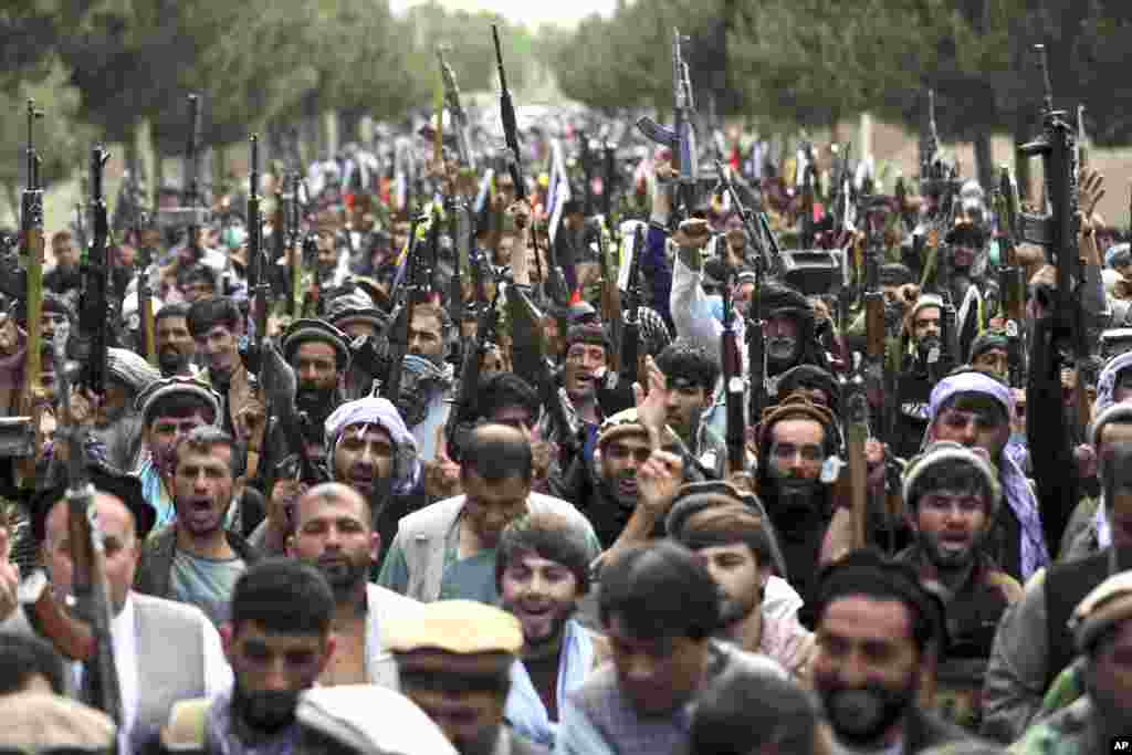 Militiamen join Afghan defense and security forces during a gathering in Kabul. Afghanistan's Defense Ministry is working with warlords to mobilize local militias across the country, most particularly in the north, to try to stem the tide of the latest Taliban gains. 