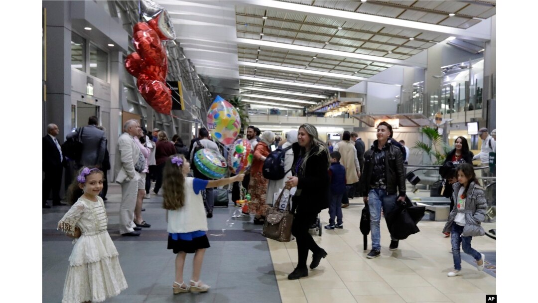 FILE - Nadia Hanan Madalo, center, and her family, refugees forced to flee their town of Batnaya, Iraq, after the Islamic State invaded and destroyed it several years ago, arrive in San Diego, California, Mar. 15, 2017.