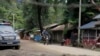 Local residents ride a motorcycle past a police checkpoint in Myanmar's border town of Maungdaw, Rakhine State, Oct. 13, 2016.