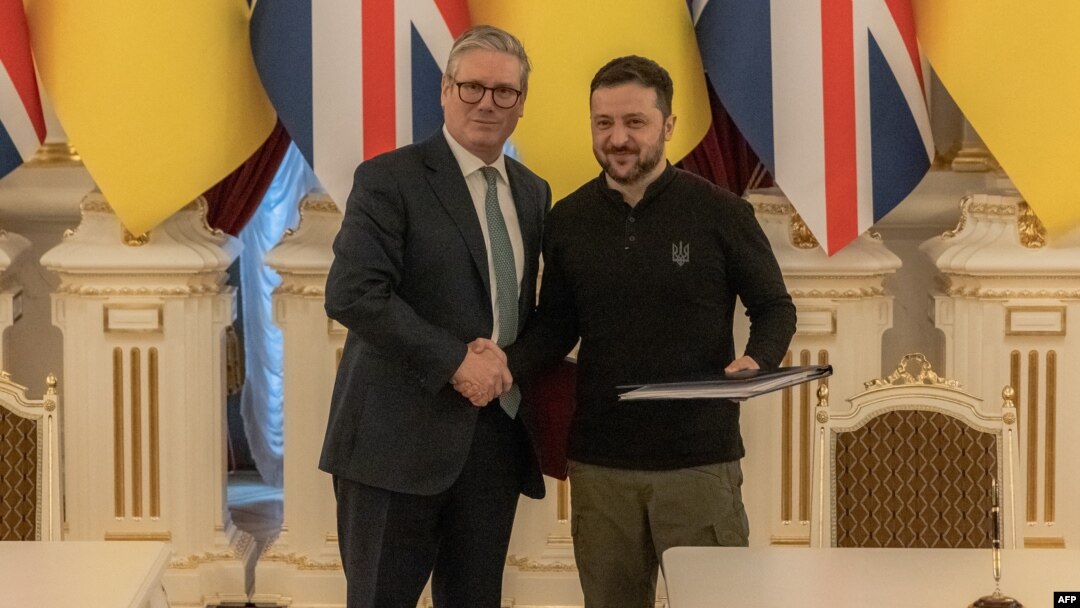 Ukraine's President Volodymyr Zelenskyy, right, shakes hands with Britain's Prime Minister Keir Starmer in Kyiv, Ukraine, after signing a 100-year agreement that pledges to strengthen defense ties between the two countries, Jan. 16, 2025.