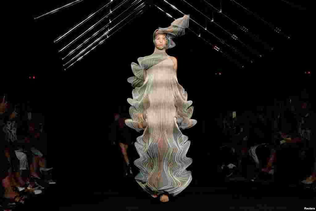 A model presents a creation by designer Iris Van Herpen as part of her Haute Couture Fall/Winter 2018/2019 collection show in Paris, France.