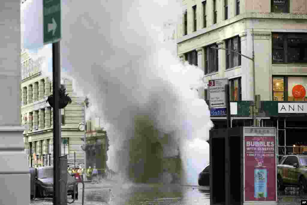 Steam billows on New York's Fifth Avenue. A steam pipe exploded beneath Fifth Avenue in Manhattan, sending chunks of asphalt flying, a geyser of billowing white steam stories into the air and forcing pedestrians to take cover.
