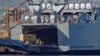 A truck carrying a container from the Danish vessel Ark Futura drives into the hold of the U.S.- owned MV Cape Ray, at Gioia Tauro port, southern Italy, July 2, 2014. 
