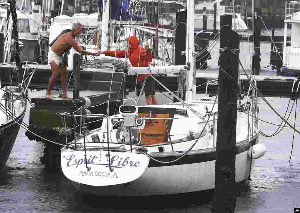 Boaters work to secure boats at a marina seeing the effects of Hurricane Ian, Sept. 28, 2022, in Saint Petersburg, Florida.