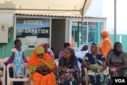 FILE - Women wait outside a health center for free breast and cervical cancer screenings, in Yoff, Dakar, Senegal, April 22, 2017. Officials say Malawi has the world's highest rate of cervical cancer. (S. Christensen/VOA)
