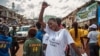 A woman celebrates with others as Sierra Leone is declared Ebola-free in Freetown, Sierra Leone, Nov. 7, 2015. 