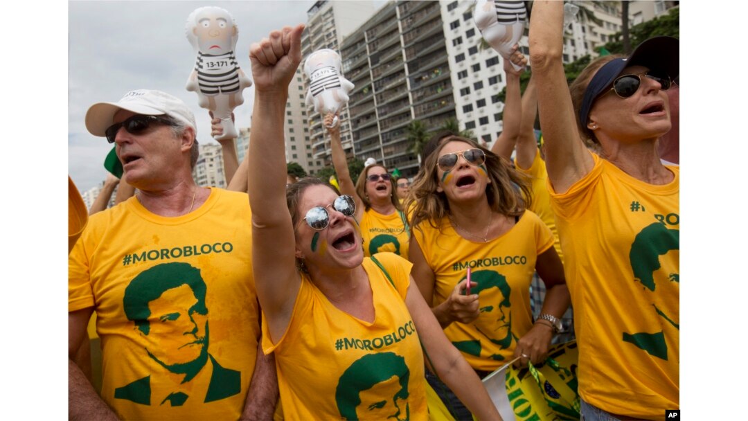 FILE - Demonstrators wear jerseys with the face of Judge Sergio Moro, who is heading the Petrobras investigation, as they protest on Copacabana beach in Rio de Janeiro, Brazil, March 13, 2016.