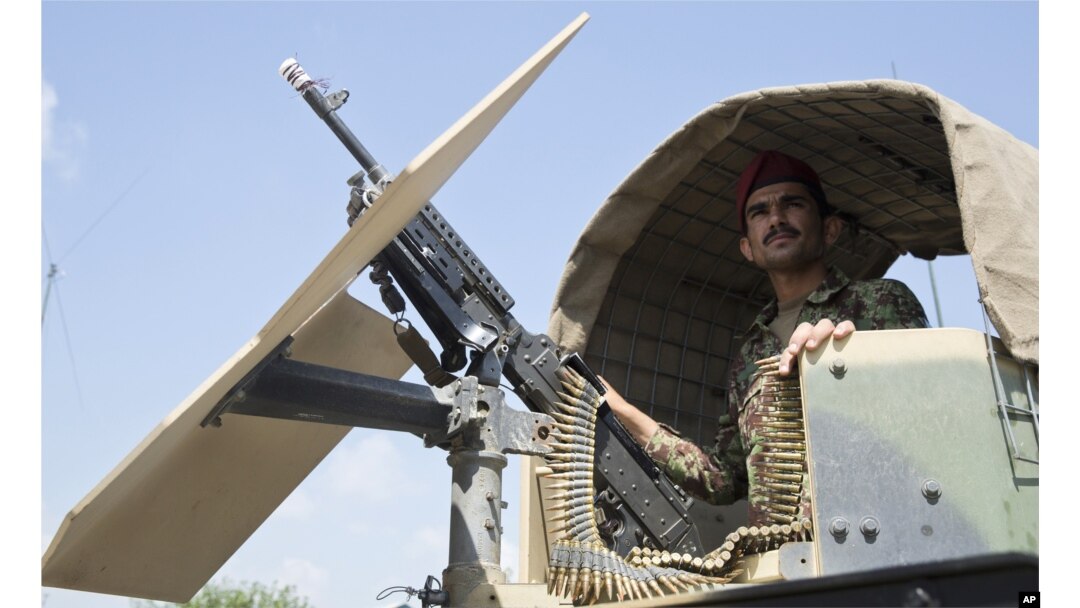 Afghanistan's National Army soldier stands guard in his vehicle in Camp Khogyani in Nangarhar province, east of Kabul, Afghanistan.