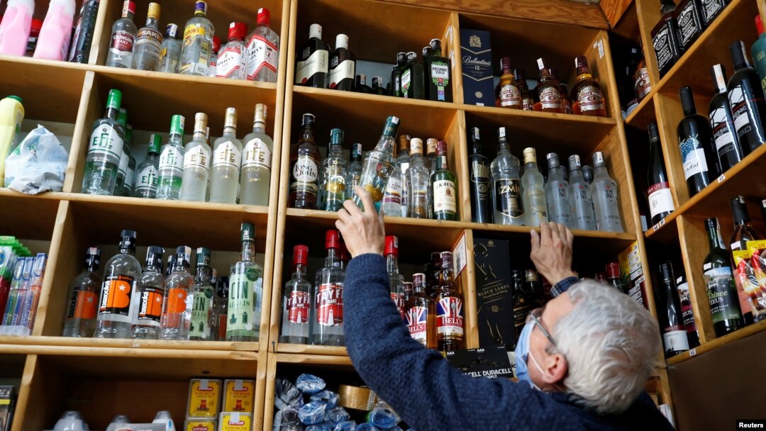 Mustafa Demirci arranges bottles of alcoholic beverages at his liquor shop ahead of a nationwide "full closure" amid the spread of the coronavirus, in Ankara, Turkey, April 28, 2021. 