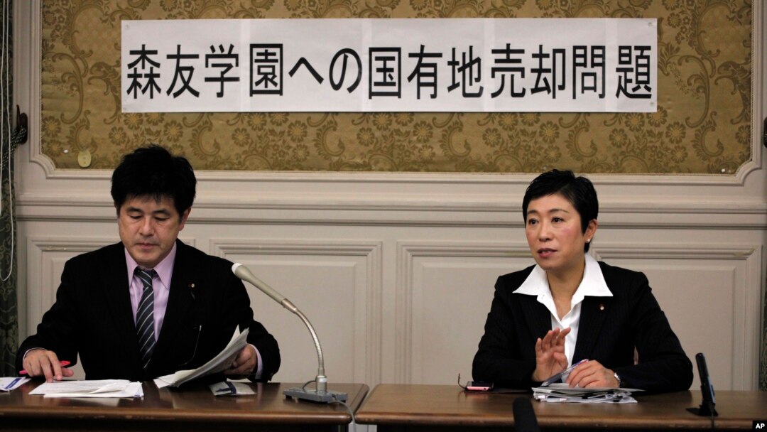 Opposition lawmakers Kiyomi Tsujimoto, right, and Masato Imai speak to reporters after visiting Osaka, western Japan, this week to investigate a scandal on a new elementary school in Tokyo, Feb. 23, 2017.