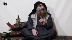 FILE - Abu Bakr al-Baghdadi purportedly appears for the first time in five years in a propaganda video in an undisclosed location, in this undated TV grab taken from video released April 29 by Al-Furqan media.