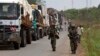 FILE - African Union peacekeepers guard a commercial convoy making its way to the border of Cameroon, near Bangui, Central African Republic, March 8, 2014.
