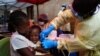FILE- A child is vaccinated against Ebola in Beni, DRC, July 13, 2019.
