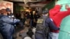 FILE - In this photo taken Aug. 17 2018, a policeman searches a suspect during a raid on a known drug house in Mannenburg, Cape Town, South Africa. 