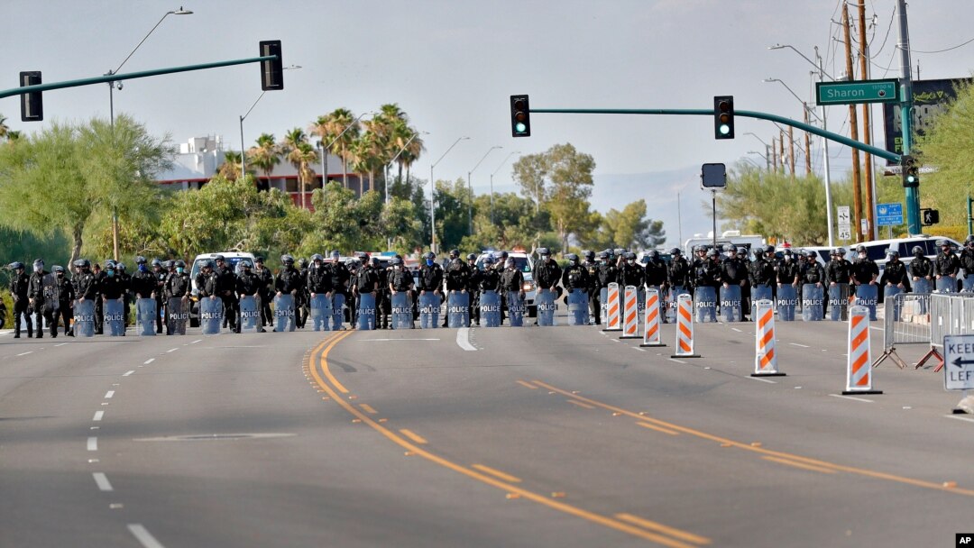 Phoenix Police clear the street after they used crowd dispersement tactics outside Dream City Church Tuesday, June 23, 2020, in Phoenix as President Donald Trump was speaking to young Republicans inside the church.