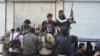 This citizen journalism image provided by Edlib News Network (ENN), purports to show Syrian rebels gathered on their vehicle in the northern town of Kfar Nebel, in Idlib province, Syria, June 5, 2012.