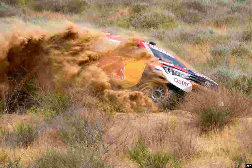 Toyota Hilux Quatar's pilot Nasser Al Attiya pilot steers his car with French co-pilot Mathieu Baumel during a shakedown close to Astrakhan, South Russian, on the eve of the start of the Silk Way Rally 2018 between Astrakhan and Moscow.