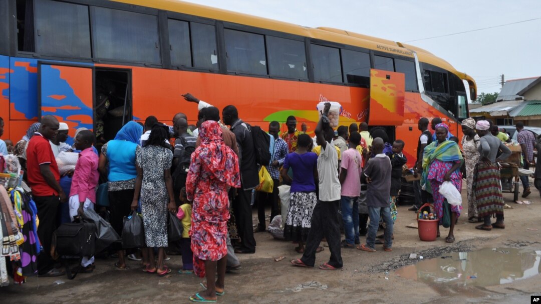 FILE - People board a commercial bus to flee after attacks by Boko Haram in Bama and other parts of Maiduguri, Nigeria, Sept. 8, 2014. 