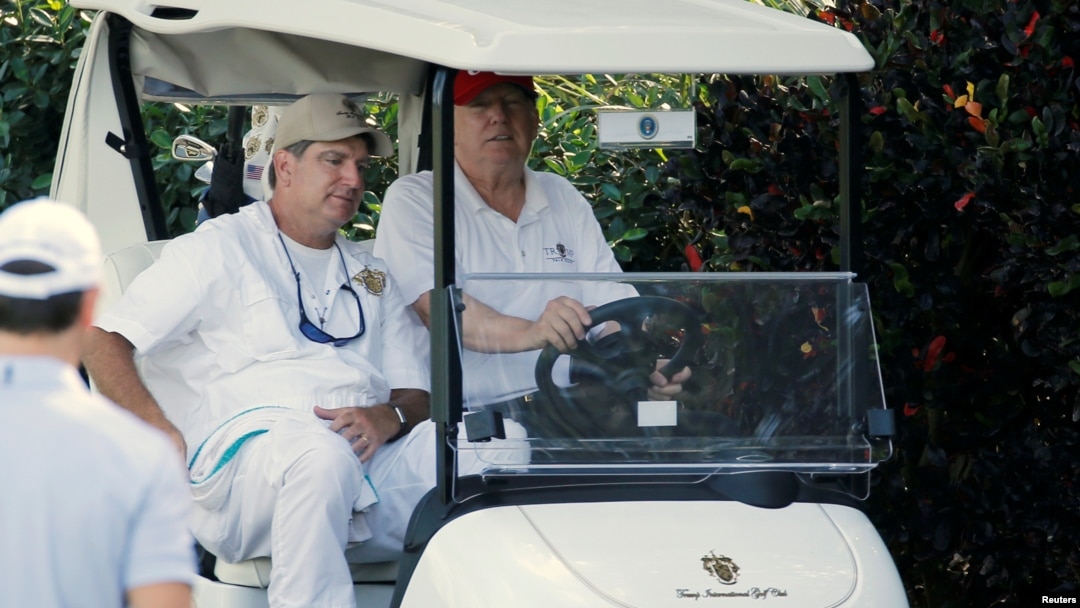 U.S. President Donald Trump arrives to play host to members of the U.S. Coast Guard he invited to play golf at his Trump International Golf Club in West Palm Beach, Fla., Dec. 29, 2017.