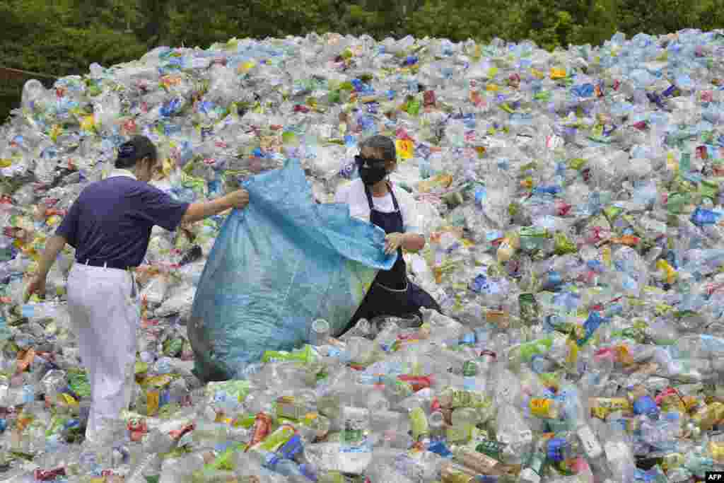 This photo taken on July 16, 2018 shows volunteers sorting out plastic bottles at a recycling centre run by a non-profit Buddhist organisation in Taipei. Taiwan started recycling plastic more than a decade ago and today it boasts more than 70 percent recycling rates, according to the Environmental Protection Administration.