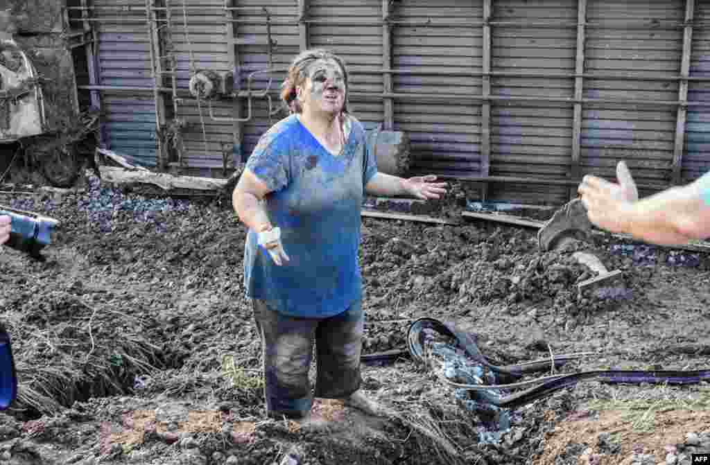 A woman reacts after a train accident at Corlu district, in Tekirdag, Turkey, July 8, 2018. Ten people were killed and 73 injured when a train packed with weekend passengers derailed in northwest Turkey, sate-run TRT Haber television said, quoting the health ministry.