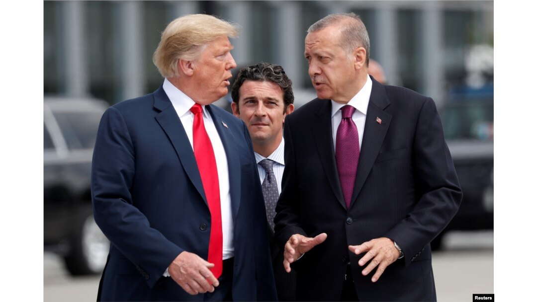 FILE - U.S. President Donald Trump and Turkish President Recep Tayyip Erdogan converse at the start of a NATO summit in Brussels, Belgium, July 11, 2018.