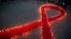 Nepalese women and children from "Maiti Nepal," a rehabilitation center for victims of sex trafficking, light candles on the eve of World AIDS Day in Kathmandu, Nepal, Nov. 30, 2016. World AIDS Day is observed December 1 every year to raise the awareness in the fight against HIV. 