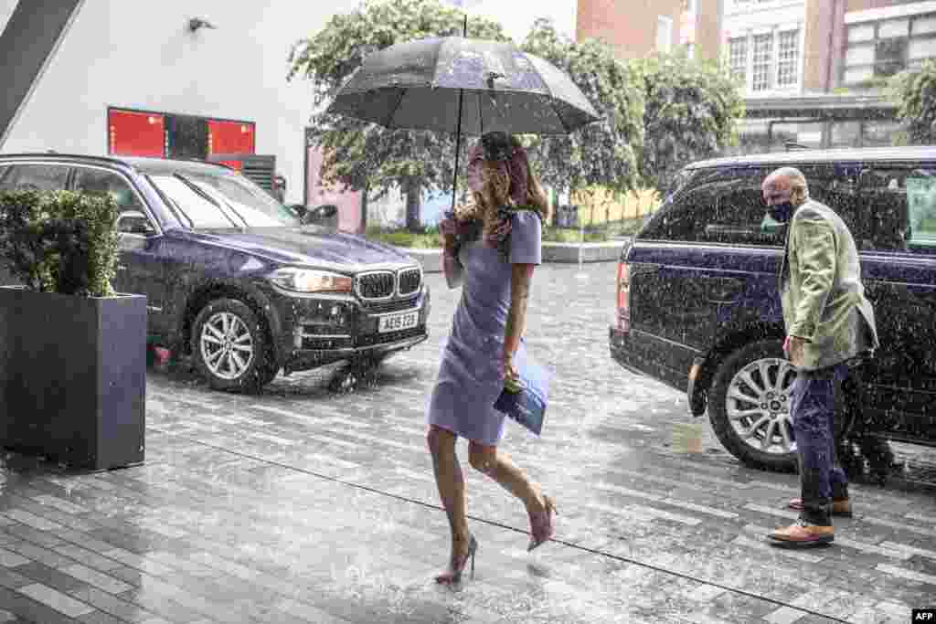 Britain's Catherine, Duchess of Cambridge, shelters from the rain under an umbrella as she arrives at the London School of Economics to mark the launch of The Royal Foundation Centre for Early Childhood, in London.