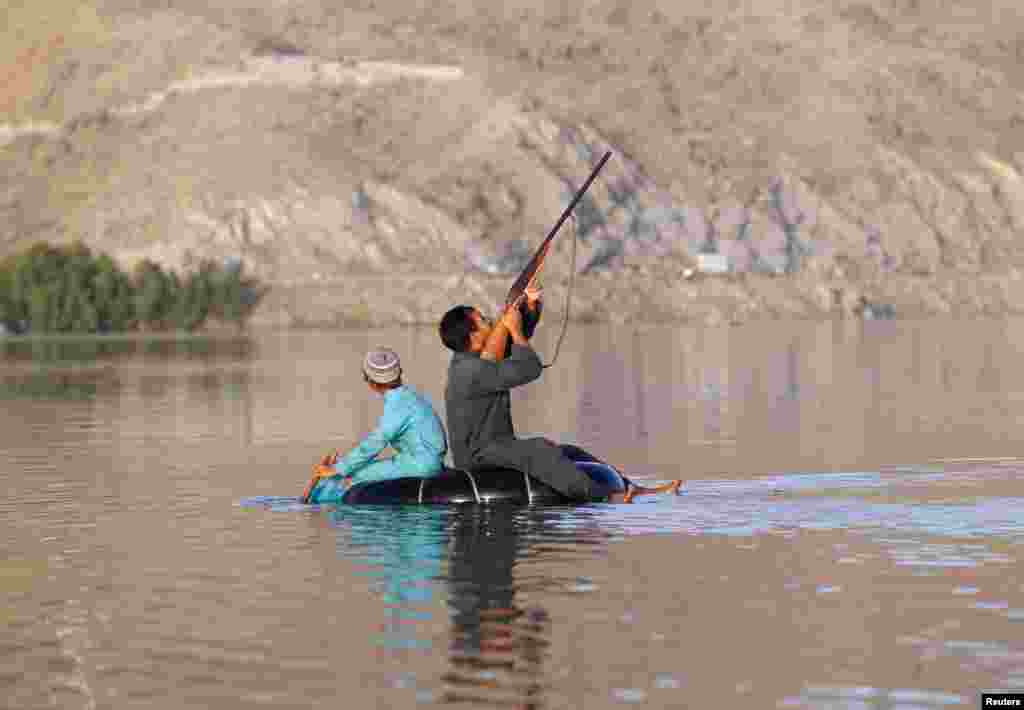 A hunter shoots at a duck in Laghman province, Afghanistan, May 30, 2018.