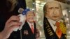 An employee polishes traditional Russian wooden nesting dolls depicting Donald Trump (L), U.S. president-elect at the time, and Russian President Vladimir Putin at a gift shop in central Moscow, Russia, Jan. 16, 2017. Russians have largely greeted Donald Trump's ascendancy to the White House with high hopes for a new era of improved relations.