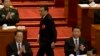 Chinese Premier Li Keqiang, center walks past Chinese President Xi Jinping, at right to deliver a work report for the opening session of the annual National People's Congress in Beijing's Great Hall of the People, March 5, 2016.