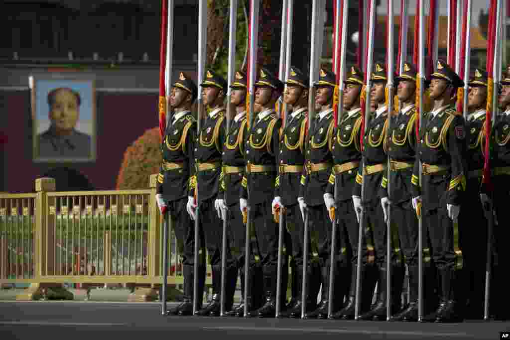 Members of a honor guard line up in formation near a large portrait of Chinese leader Mao Zedong on Tiananmen Gate before a welcome ceremony for Kazakhstan's President Nursultan Nazarbayev at the Great Hall of the People in Beijing.