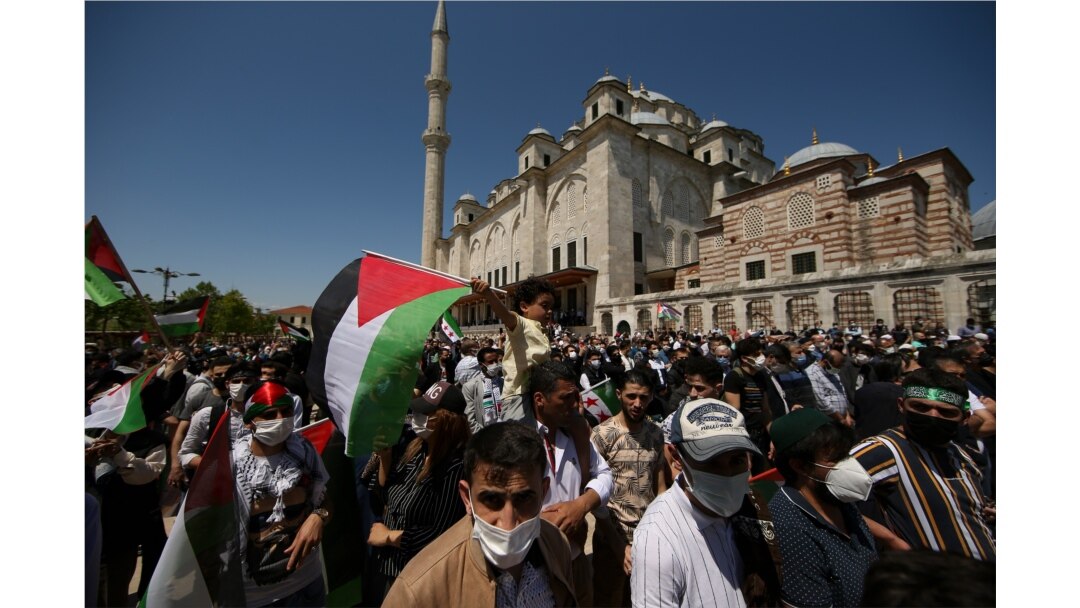 A child holds a Palestinian flag during a rally outside Fatih mosque in Istanbul, May 4, 2021, in support of Palestinians, killed in the recent escalation of violence in Jerusalem and the Gaza Strip.