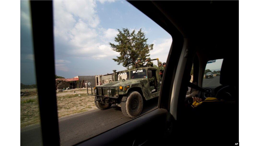 A military convoy patrols a road near Palmarito Tochapan in Puebla State, May 10, 2017.