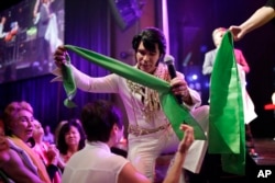 Ted Torres hands out scarves to fans at the "Images of the King: Las Vegas" festival in Las Vegas, July 15, 2017. Fans at performances will line up along the stage to receive the sweat-soaked souvenirs from performers.