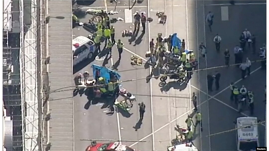 Police and emergency services attend to the scene of an incident involving a vehicle on Flinders Street, as seen from Swanson Street, in Melbourne, Australia, Dec. 21, 2017.