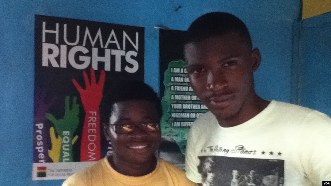 George Freeman (glasses) and co-worker Bernard Wilson at their Freetown office. (VOA - N. deVries)