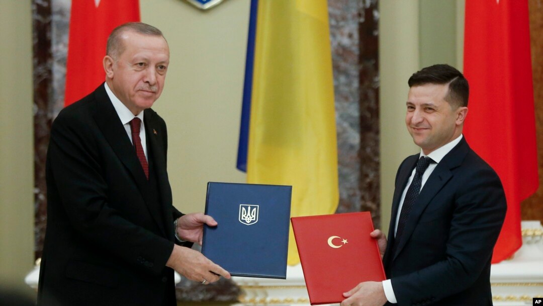 Ukrainian President Volodymyr Zelenskiy, right, and Turkey's President Recep Tayyip Erdogan pose for a photo during a signing ceremony in Kyiv, Ukraine, Feb. 3, 2020.