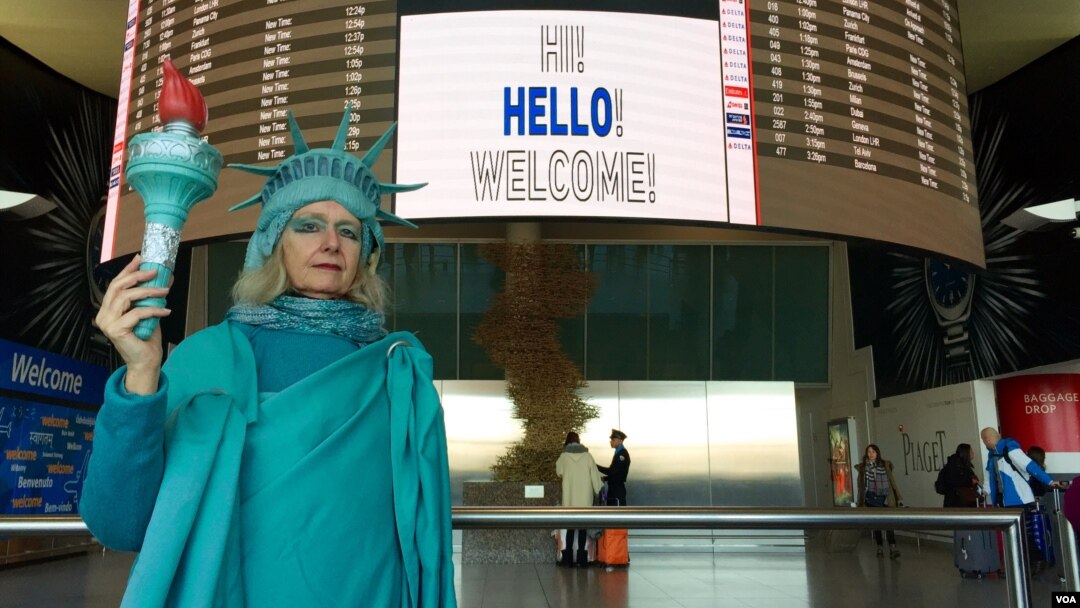 Lindley Hanlon, a film professor at CUNY, spent Monday afternoon at JFK International Airport to welcome refugees. "I'm trying to welcome people to our shores, as I've always done for 131 years,” she said, referring to Lady Liberty’s arrival in New York harbor in June of 1885. (Ramon Taylor/VOA)