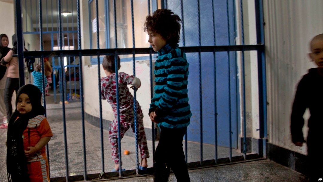 FILE - Children walking through the prison in Badam Bagh, Afghanistan's central women's prison, in Kabul.
