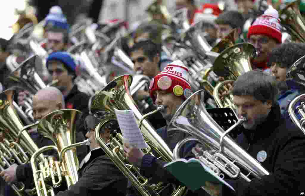 Musicians play brass instruments for the 35th Annual Dallas Merry Tubachristmas Concert at Thanks-Giving Square in downtown Dallas, Texas, December 24, 2012.
